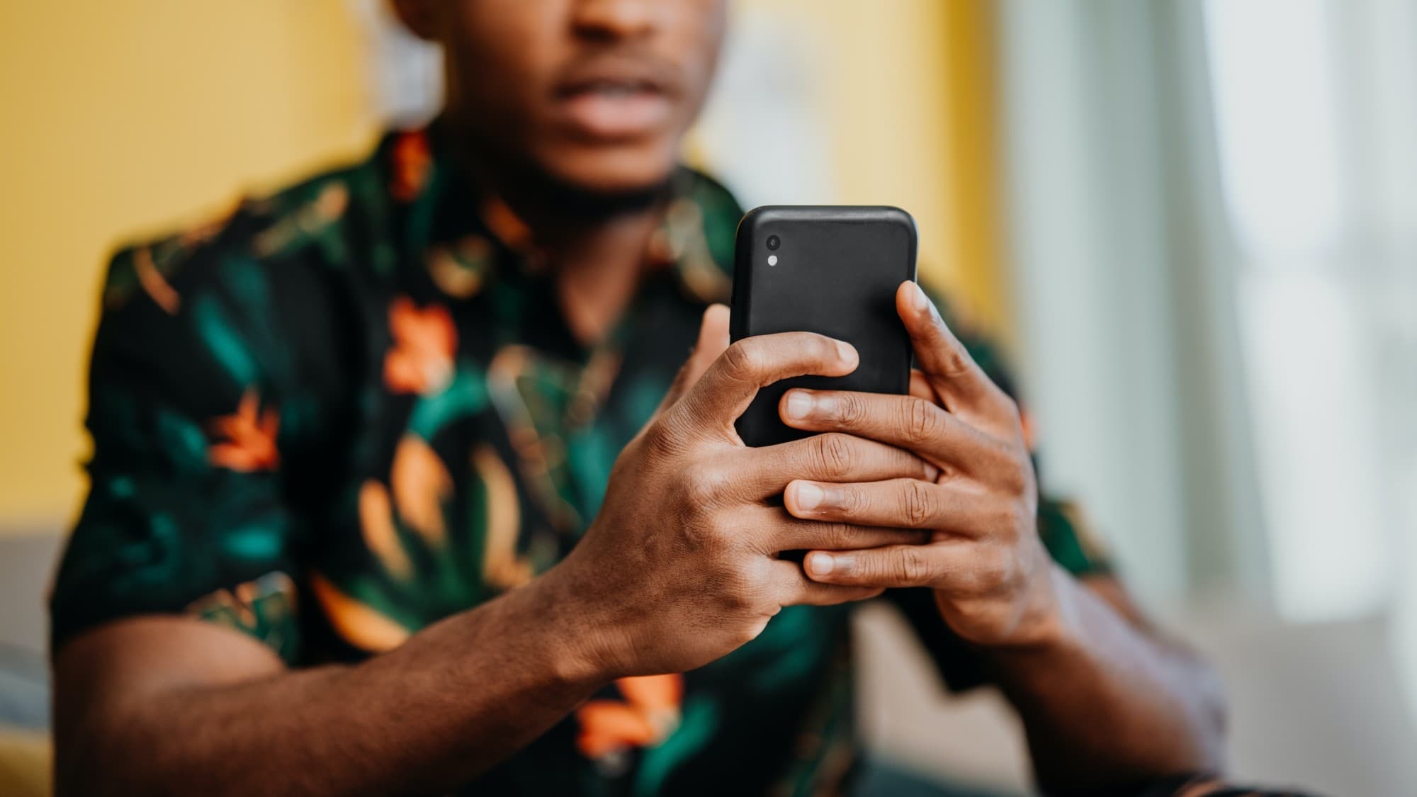 Hands holding a phone used to take an order
